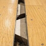 Damaged gym floor with warping and stains
