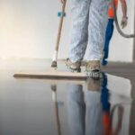 Worker cleaning a commercial epoxy floor surface