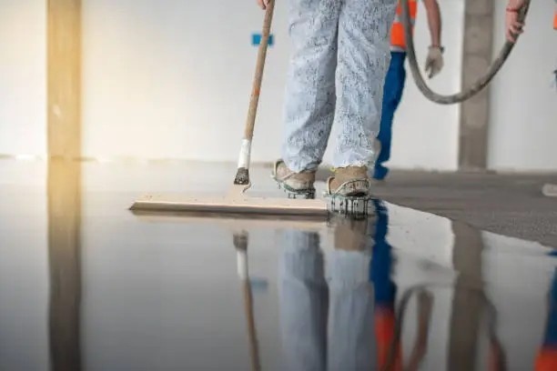 Worker cleaning a commercial epoxy floor surface