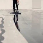 Shiny commercial epoxy flooring in a clean industrial or retail space with polished reflective surface