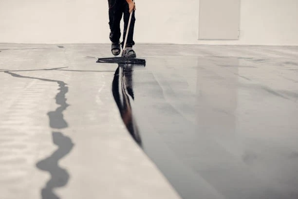 Shiny commercial epoxy flooring in a clean industrial or retail space with polished reflective surface