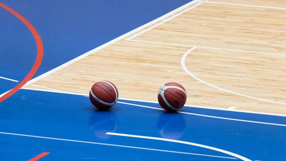 Indoor hardwood basketball court in a Colorado school gym designed for durability, player safety, and long-term athletic performance.