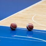 Indoor hardwood basketball court in a Colorado school gym designed for durability, player safety, and long-term athletic performance.
