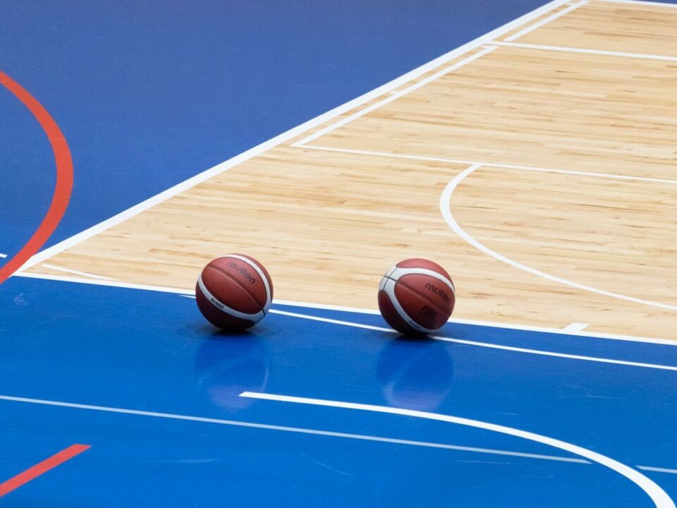 Indoor hardwood basketball court in a Colorado school gym designed for durability, player safety, and long-term athletic performance.