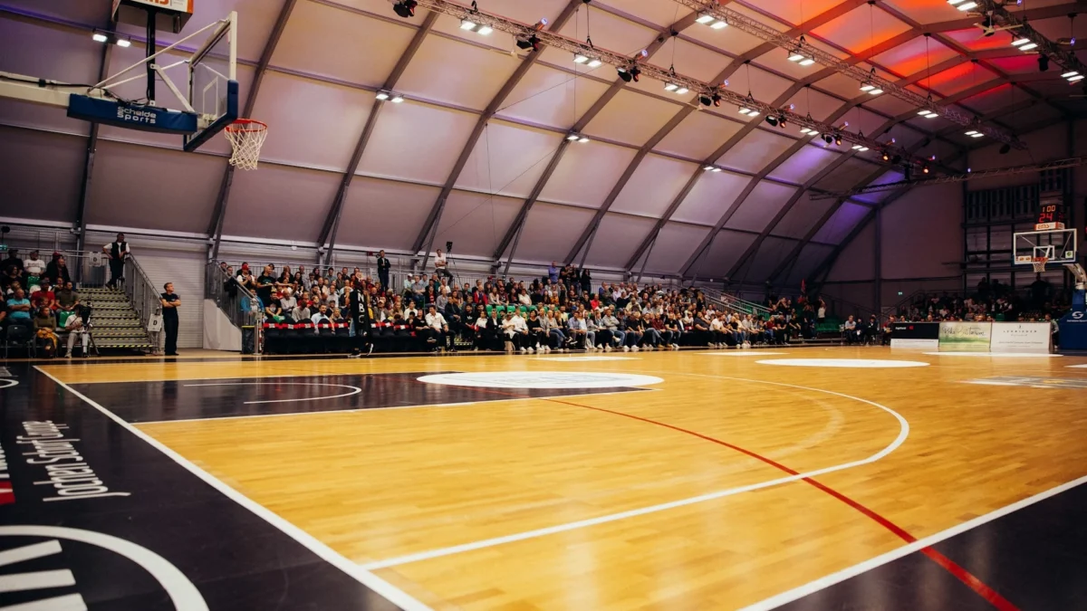 Professional hardwood basketball court flooring with polished maple surface for indoor sports facilities.