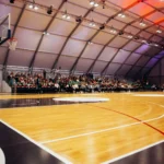 Professional hardwood basketball court flooring with polished maple surface for indoor sports facilities.