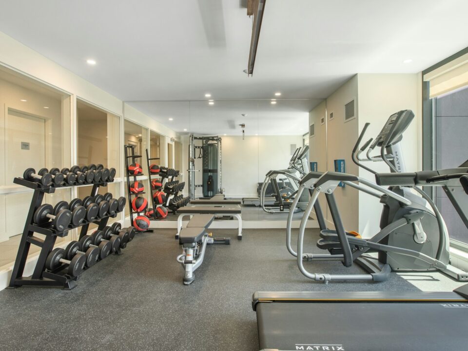 Best home gym flooring options including rubber, hardwood, foam, and epoxy